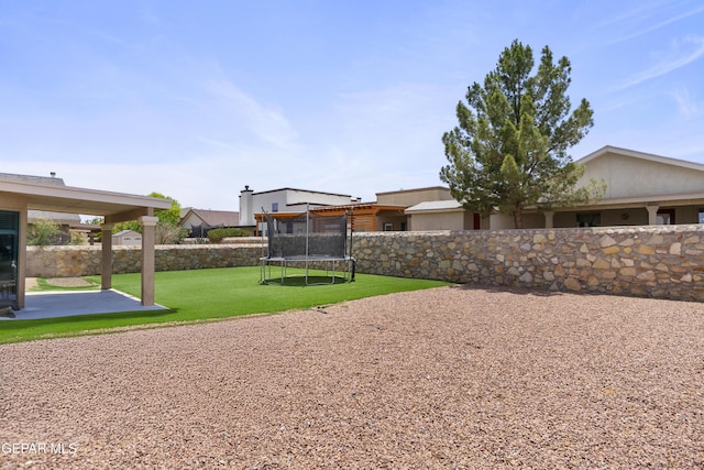 1497 Dunlin Pl, El Paso, TX 79928 - fenced backyard featuring a trampoline and a patio
