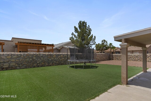 1497 Dunlin Pl, El Paso, TX 79928 - fenced backyard featuring a trampoline and a patio area