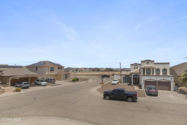 1497 Dunlin Pl, El Paso, TX 79928 - view of asphalt road with street lighting, a residential view, curbs, and sidewalks
