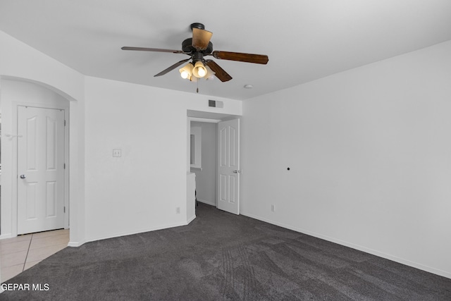 1497 Dunlin Pl, El Paso, TX 79928 - unfurnished room with a ceiling fan, carpet, arched walkways, and tile patterned flooring