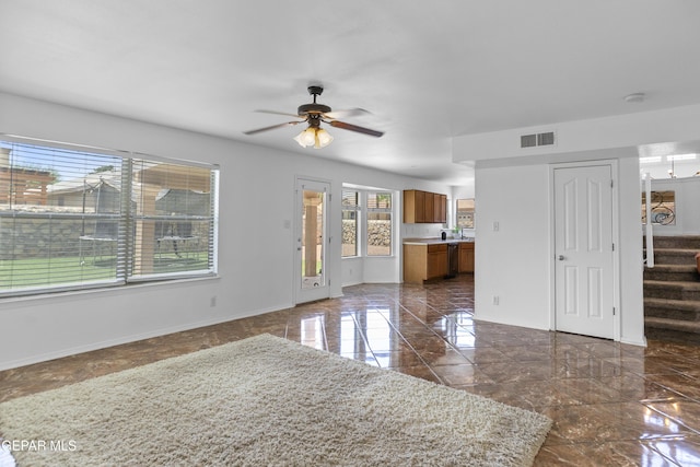 1497 Dunlin Pl, El Paso, TX 79928 - unfurnished living room featuring ceiling fan, stairs, and dark marble finish floors