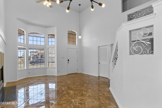 1497 Dunlin Pl, El Paso, TX 79928 - entryway with a towering ceiling, marble tiled flooring, and a fireplace