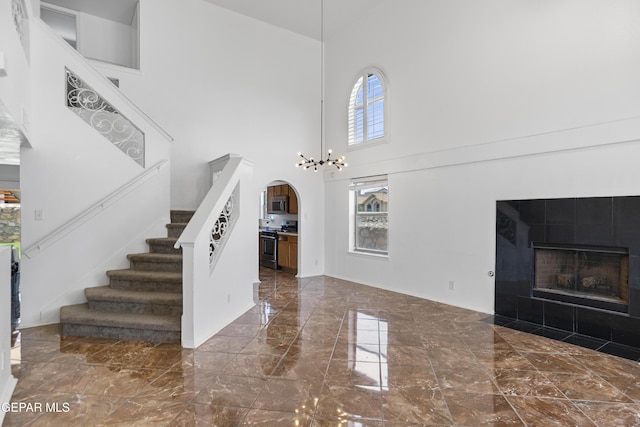 1497 Dunlin Pl, El Paso, TX 79928 - foyer entrance with a towering ceiling, marble tiled floors, stairs, arched walkways, and a fireplace