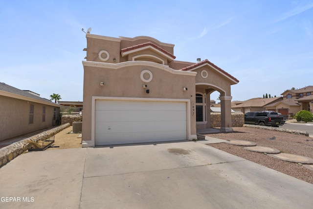 1497 Dunlin Pl, El Paso, TX 79928 - view of front facade featuring stucco siding, driveway, a garage, and a tile roof