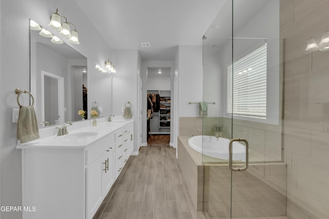 13727 Harbottle St, El Paso, TX 79928 - full bath with a spacious closet, a shower stall, double vanity, and a garden tub