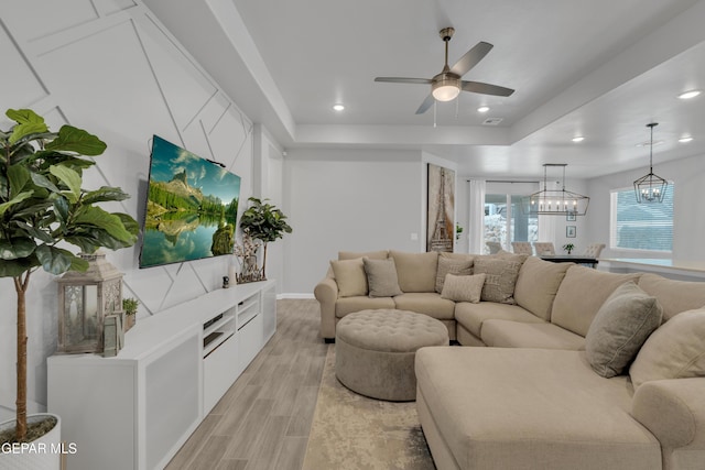 13727 Harbottle St, El Paso, TX 79928 - living room with ceiling fan, light wood-style floors, a raised ceiling, a chandelier, and recessed lighting
