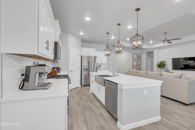 13727 Harbottle St, El Paso, TX 79928 - kitchen featuring appliances with stainless steel finishes, a sink, ceiling fan, recessed lighting, and white cabinetry