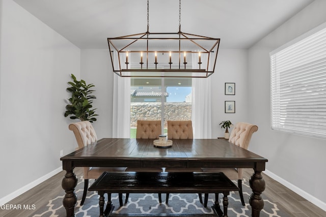 13727 Harbottle St, El Paso, TX 79928 - dining area with wood finished floors, baseboards, and a chandelier