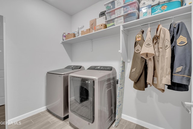 13727 Harbottle St, El Paso, TX 79928 - laundry area with washing machine and dryer, wood finish floors, and baseboards