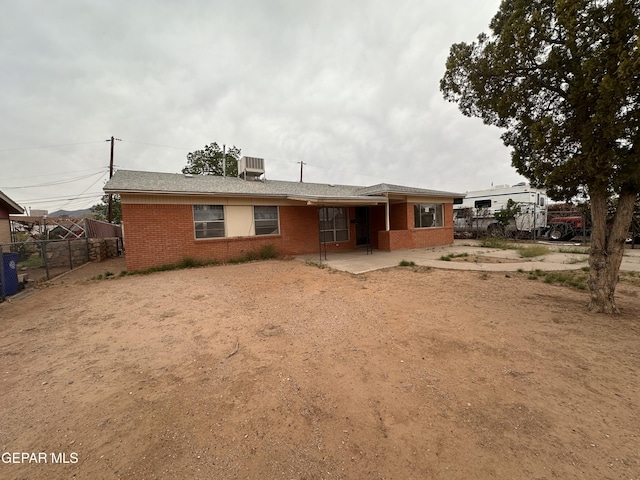 10041 Newcastle Dr, El Paso, TX 79924 - back of house with brick siding, driveway, and central AC