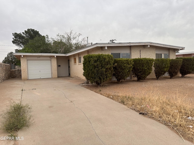 5537 Vancouver St, El Paso, TX 79924 - ranch-style house featuring brick siding, an attached garage, and driveway