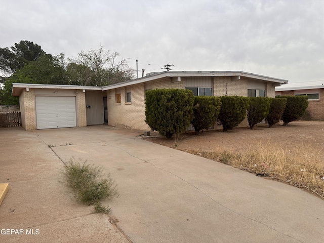 5537 Vancouver St, El Paso, TX 79924 - ranch-style home with brick siding, a garage, and concrete driveway