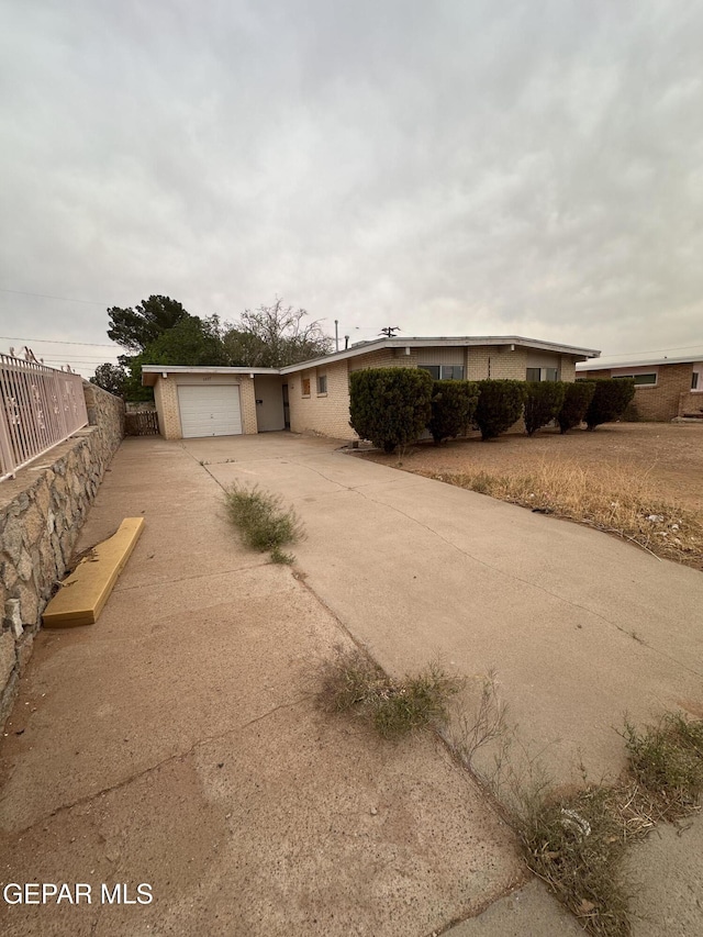 5537 Vancouver St, El Paso, TX 79924 - view of front facade featuring concrete driveway and a garage
