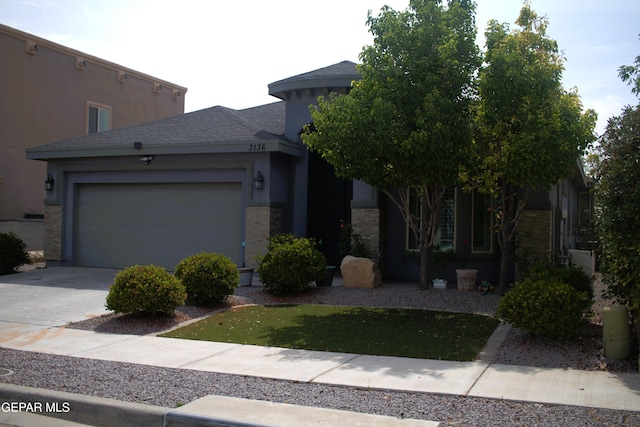 3136 Red Crk, El Paso, TX 79938 - view of front facade with concrete driveway, an attached garage, roof with shingles, and stucco siding