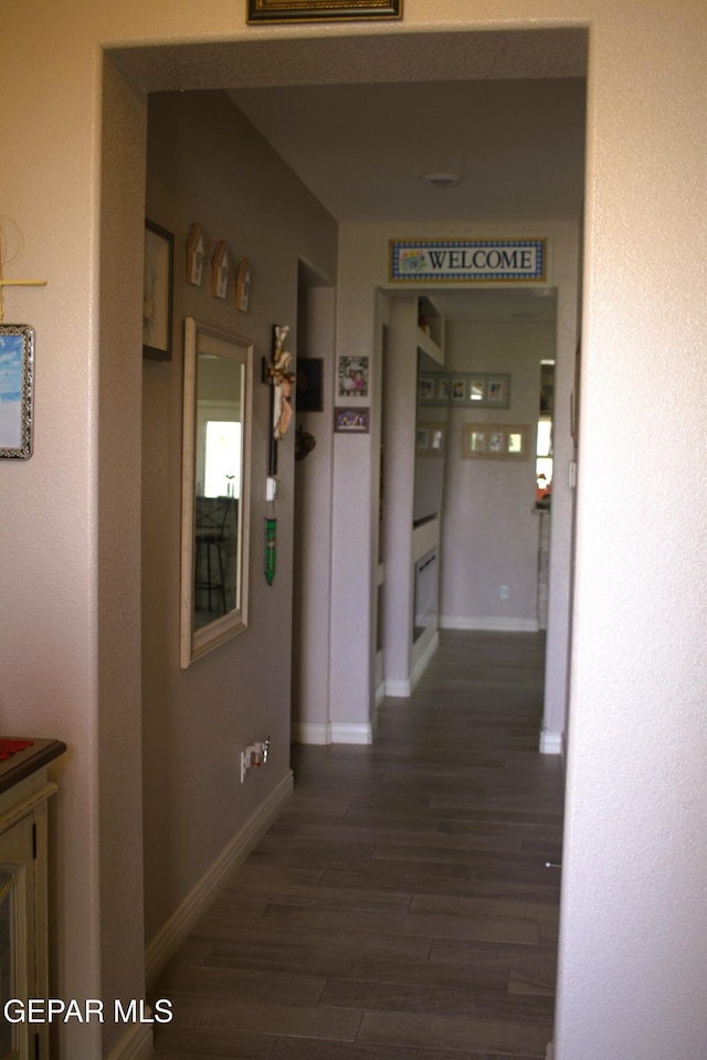 3136 Red Crk, El Paso, TX 79938 - hall featuring dark wood-style flooring and baseboards