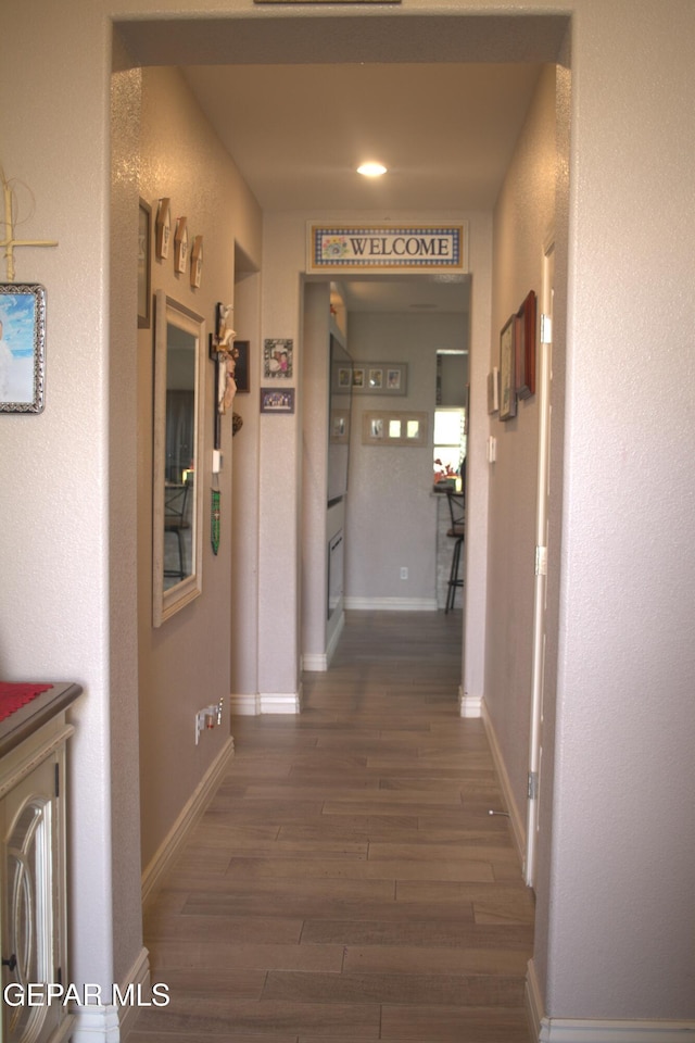 3136 Red Crk, El Paso, TX 79938 - corridor with dark wood-style floors and baseboards