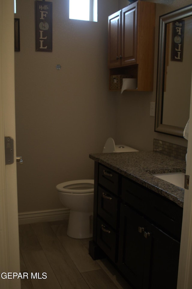 3136 Red Crk, El Paso, TX 79938 - bathroom featuring vanity, toilet, and baseboards