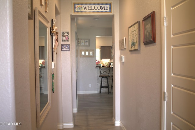 3136 Red Crk, El Paso, TX 79938 - corridor with dark wood finished floors, baseboards, and a textured wall