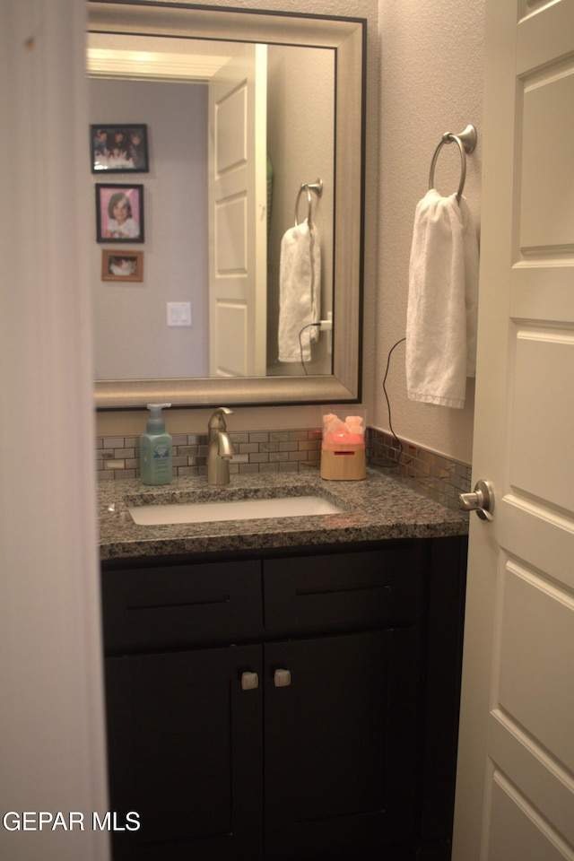 3136 Red Crk, El Paso, TX 79938 - bathroom with vanity and decorative backsplash