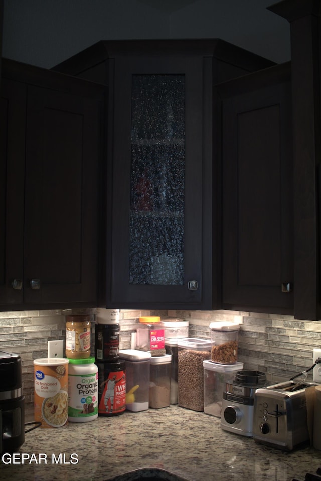 3136 Red Crk, El Paso, TX 79938 - kitchen featuring backsplash, dark cabinets, and light countertops