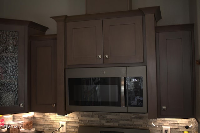 3136 Red Crk, El Paso, TX 79938 - kitchen view of stainless steel microwave, backsplash, and gray cabinetry