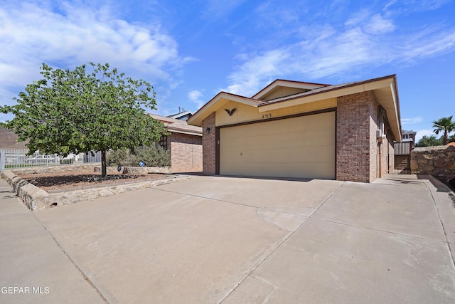 4513 Gen Maloney Cir, El Paso, TX 79924 - single story home with concrete driveway, brick siding, and a garage