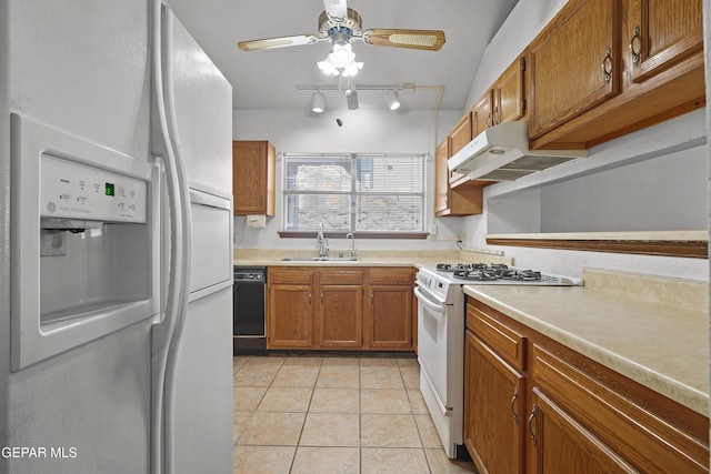 4513 Gen Maloney Cir, El Paso, TX 79924 - kitchen with white appliances, a sink, under cabinet range hood, brown cabinetry, and light tile patterned floors