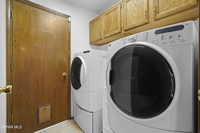 4513 Gen Maloney Cir, El Paso, TX 79924 - laundry room with separate washer and dryer, cabinet space, light tile patterned floors, and a textured ceiling