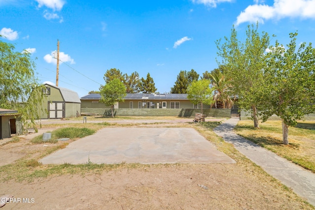 5300 Crawford Rd, Santa Teresa, NM 88008 - view of front facade featuring roof mounted solar panels and a front yard