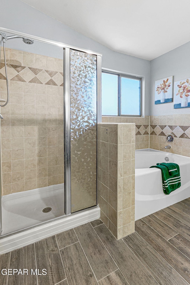 14045 Tower Point Way, El Paso, TX 79938 - bathroom featuring wood finished floors, a shower stall, and a bath