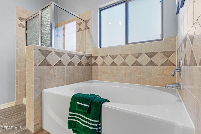 14045 Tower Point Way, El Paso, TX 79938 - bathroom featuring a garden tub, a shower stall, wood finished floors, and tile walls