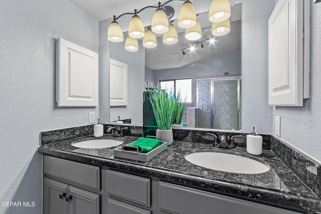 14045 Tower Point Way, El Paso, TX 79938 - full bath with double vanity, a shower stall, and a textured wall