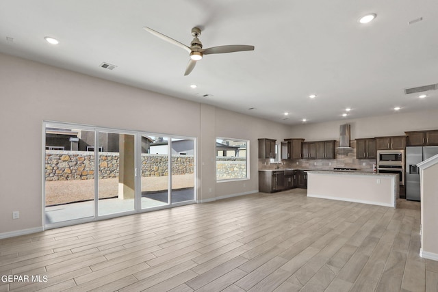 3952 Aspiration St, El Paso, TX 79938 - unfurnished living room with ceiling fan, light wood-style flooring, baseboards, a sink, and recessed lighting