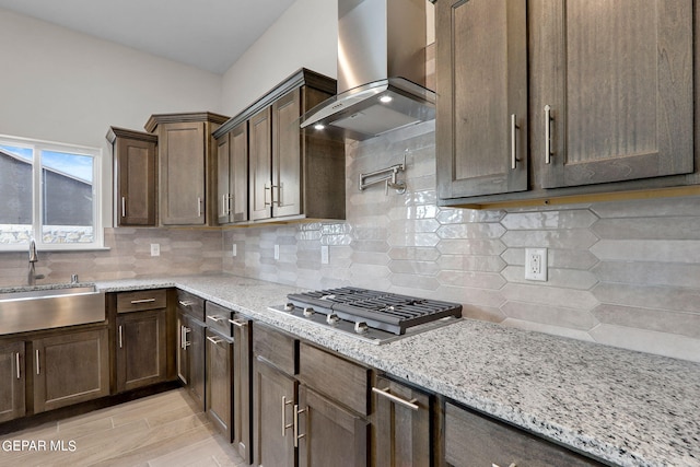3952 Aspiration St, El Paso, TX 79938 - kitchen featuring a sink, ventilation hood, stainless steel gas cooktop, light stone countertops, and decorative backsplash
