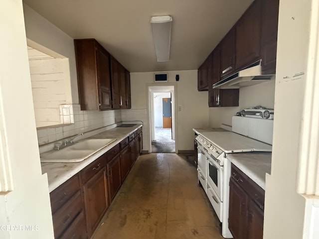 5609 Venezuela Rd, El Paso, TX 79903 - kitchen with a sink, under cabinet range hood, double oven range, light countertops, and dark brown cabinets