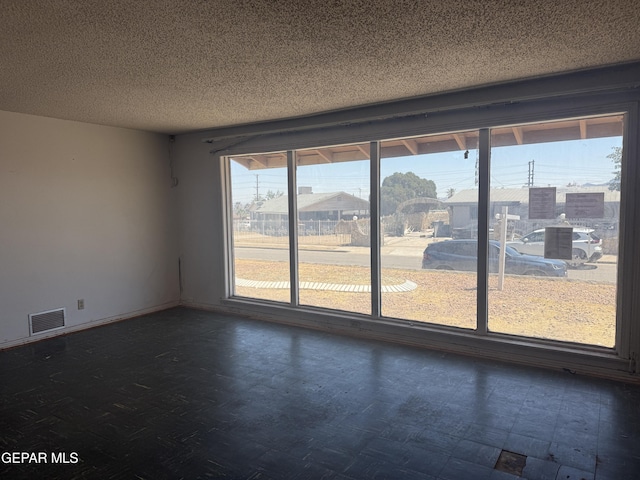 5609 Venezuela Rd, El Paso, TX 79903 - unfurnished room with a textured ceiling and dark floors