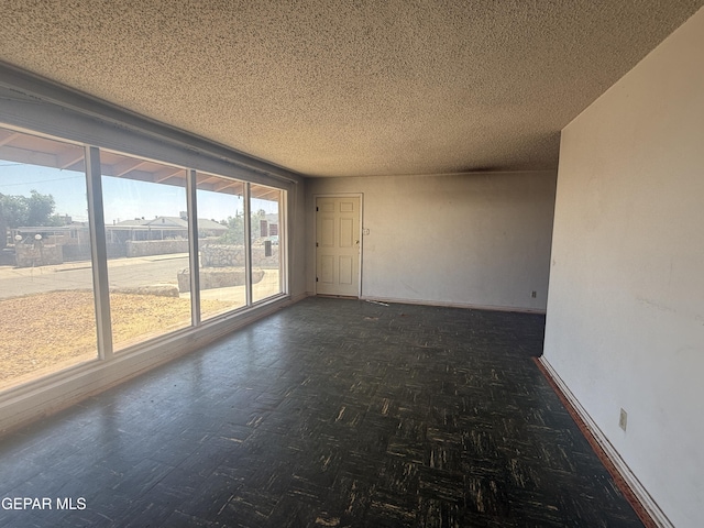 5609 Venezuela Rd, El Paso, TX 79903 - spare room with baseboards and a textured ceiling