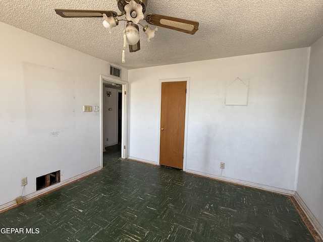 5609 Venezuela Rd, El Paso, TX 79903 - spare room with a ceiling fan, baseboards, a textured ceiling, and a fireplace
