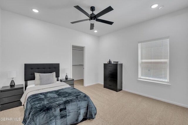 13873 Madero Ave, Horizon City, TX 79928 - bedroom with light colored carpet, recessed lighting, a walk in closet, and a ceiling fan
