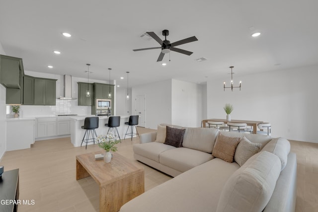 13873 Madero Ave, Horizon City, TX 79928 - living room with a chandelier, ceiling fan, and recessed lighting