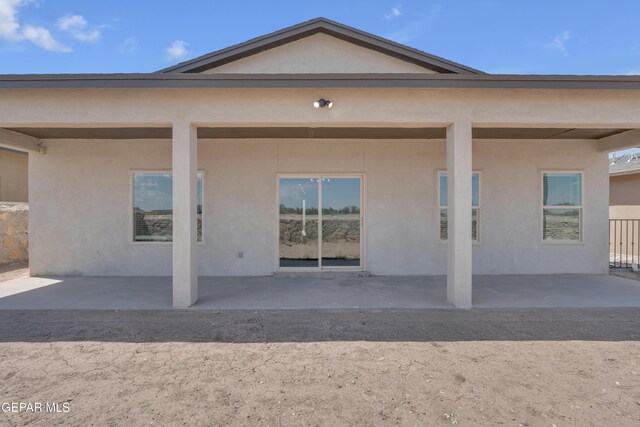 13873 Madero Ave, Horizon City, TX 79928 - rear view of house featuring stucco siding and a patio