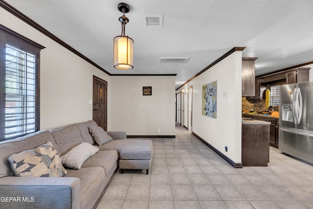 9549 Albany Dr, El Paso, TX 79924 - living room featuring ornamental molding, baseboards, and light tile patterned flooring