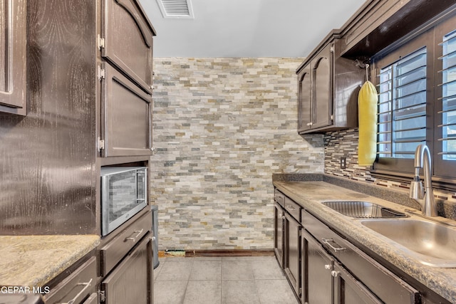 9549 Albany Dr, El Paso, TX 79924 - kitchen with a sink, stainless steel microwave, and light tile patterned floors