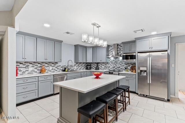 16006 Darley Dr, Horizon City, TX 79928 - kitchen featuring stainless steel appliances, gray cabinetry, wall chimney exhaust hood, a sink, and recessed lighting