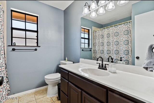 16006 Darley Dr, Horizon City, TX 79928 - bathroom featuring vanity, toilet, tile patterned floors, and baseboards
