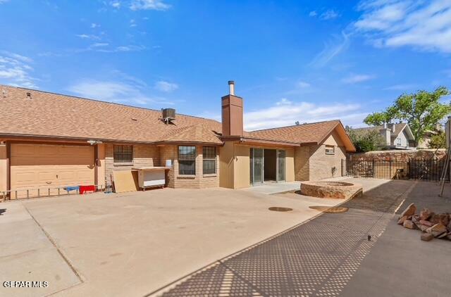 16006 Darley Dr, Horizon City, TX 79928 - back of property with a chimney and a patio