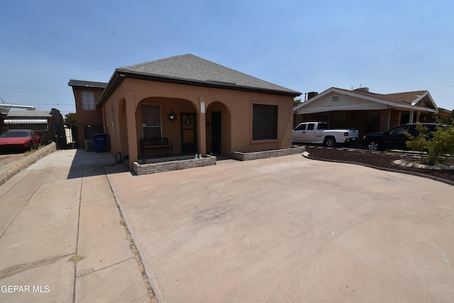 3608 Douglas Ave, El Paso, TX 79903 - view of front of house with a porch, stucco siding, and a shingled roof