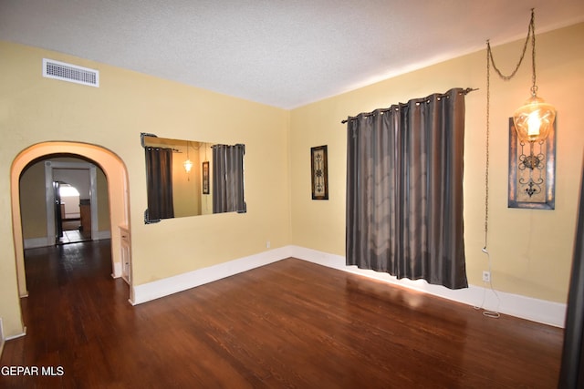 3608 Douglas Ave, El Paso, TX 79903 - empty room featuring wood finished floors, arched walkways, and baseboards