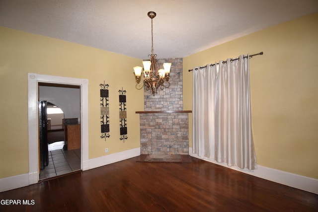 3608 Douglas Ave, El Paso, TX 79903 - unfurnished dining area with wood finished floors, a chandelier, and baseboards