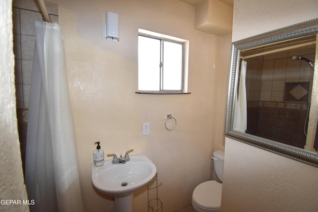 3608 Douglas Ave, El Paso, TX 79903 - bathroom featuring a sink, toilet, and a shower with curtain